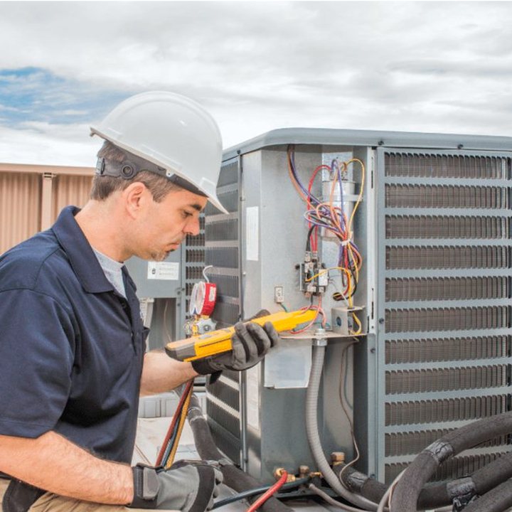 Goderich Heating & Cooling HVAC technician servicing a system in a Huron County home